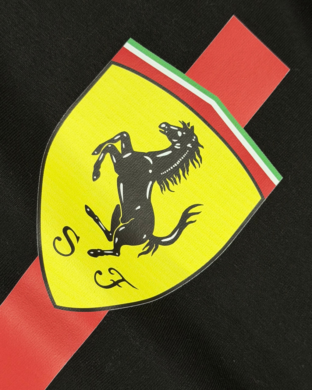 Closeup of F1 Black Unisex regular fit T-shirt by Turn 1 Brand, an F1 Apparel brand of India. Charles Leclerc fan tshirt with Front print features Ferrari logo and Charles Leclerc signature.