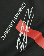Closeup of F1 Black Unisex regular fit T-shirt by Turn 1 Brand, an F1 Apparel brand of India. Charles Leclerc fan tshirt with Front print features Ferrari logo and Charles Leclerc signature.