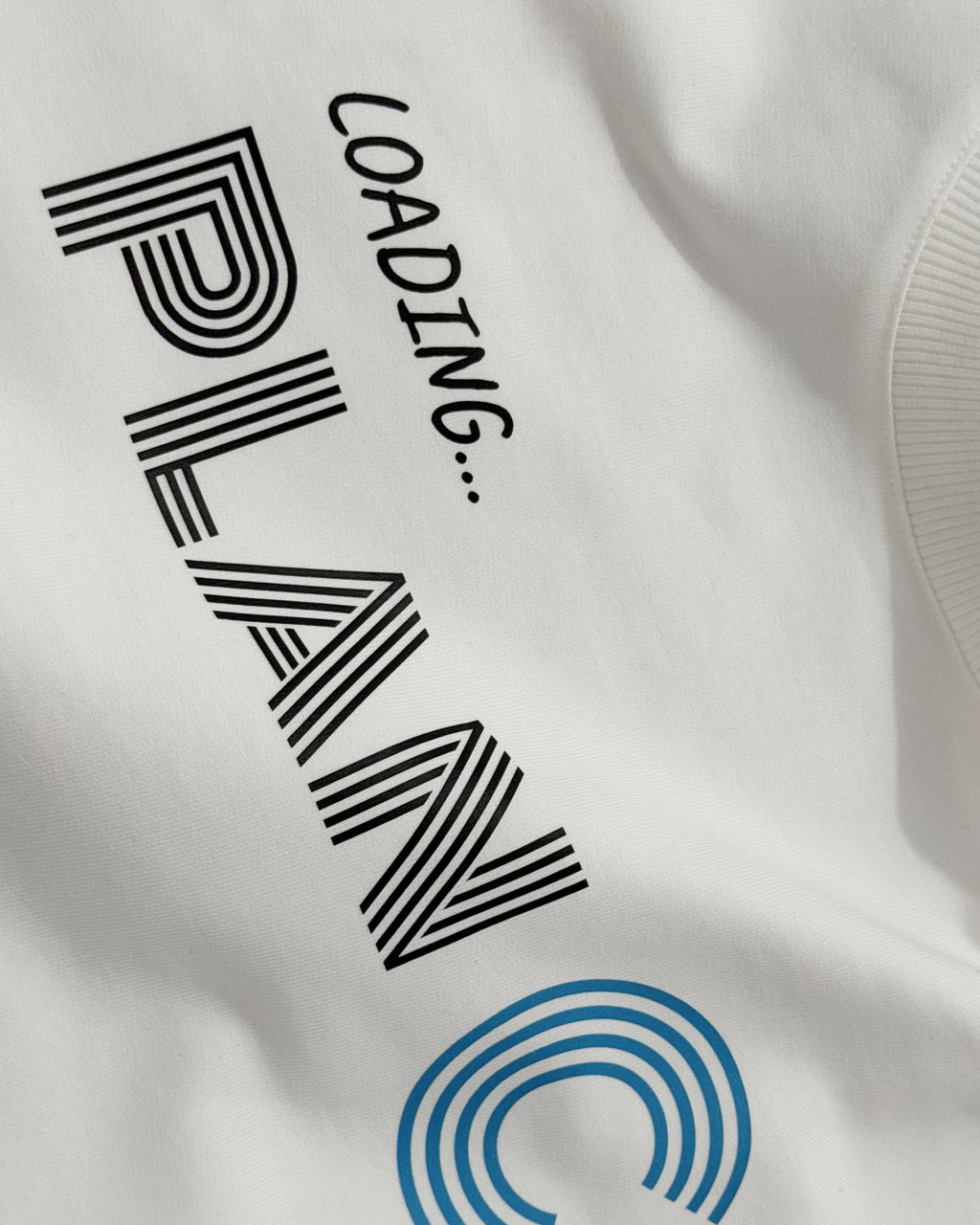 Closeup of cotton fabric of F1 Turn1 India Off White Oversized Unisex Tshirt featuring fan graphic Charles Leclerc, current driver for Scuderia Ferrari F1 team. Tshirt features Charles Leclerc graphic, his number "16" and his Ferrari car.
Front print text "Plan C" in black.