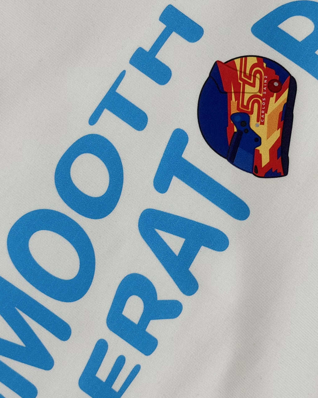 Close-up of F1 Turn1 India White crop top with “SMOOTH OPERATOR” graphic on the front based on driver Carlos Sainz Jr - driver of Williams F1 Racing team