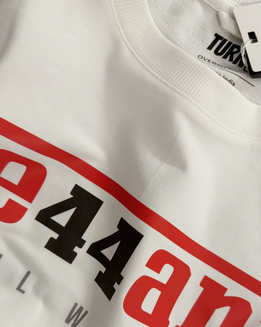 Close-up Image of Fabric and Print - Lewis Hamilton Ferrari 44 Still We Rise F1 Unisex Oversized Fan Graphic T-shirt Off-White | Turn1 India