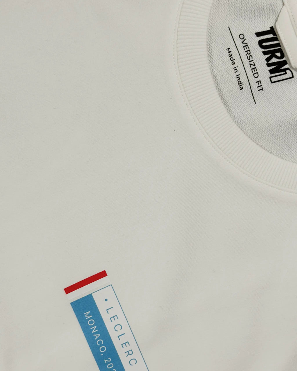 Close-up image of Fabric and Print  Charles Leclerc Monaco Edition F1 Unisex Oversized T-shirt Off-White | Turn1 India