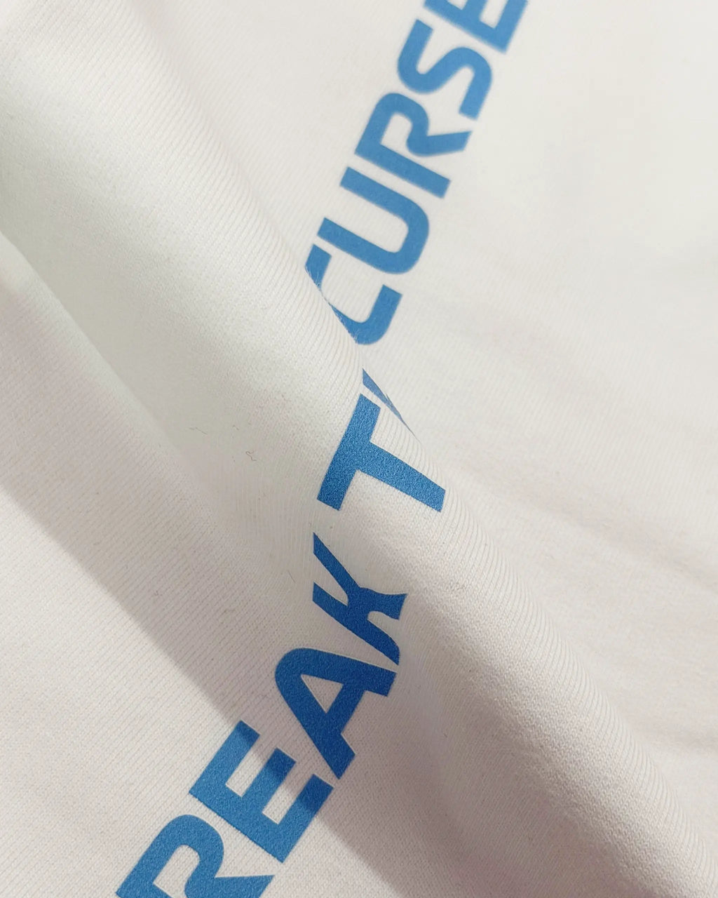 Close-up image of Fabric and Print  Charles Leclerc Monaco Edition F1 Unisex Oversized T-shirt Off-White | Turn1 India