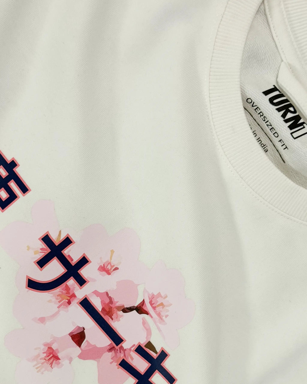 Closeup image of fabric and print | Suzuka Circuit Japan Grand Prix F1 Unisex Oversized Graphic T-shirt Off-White Side View | Turn1 India