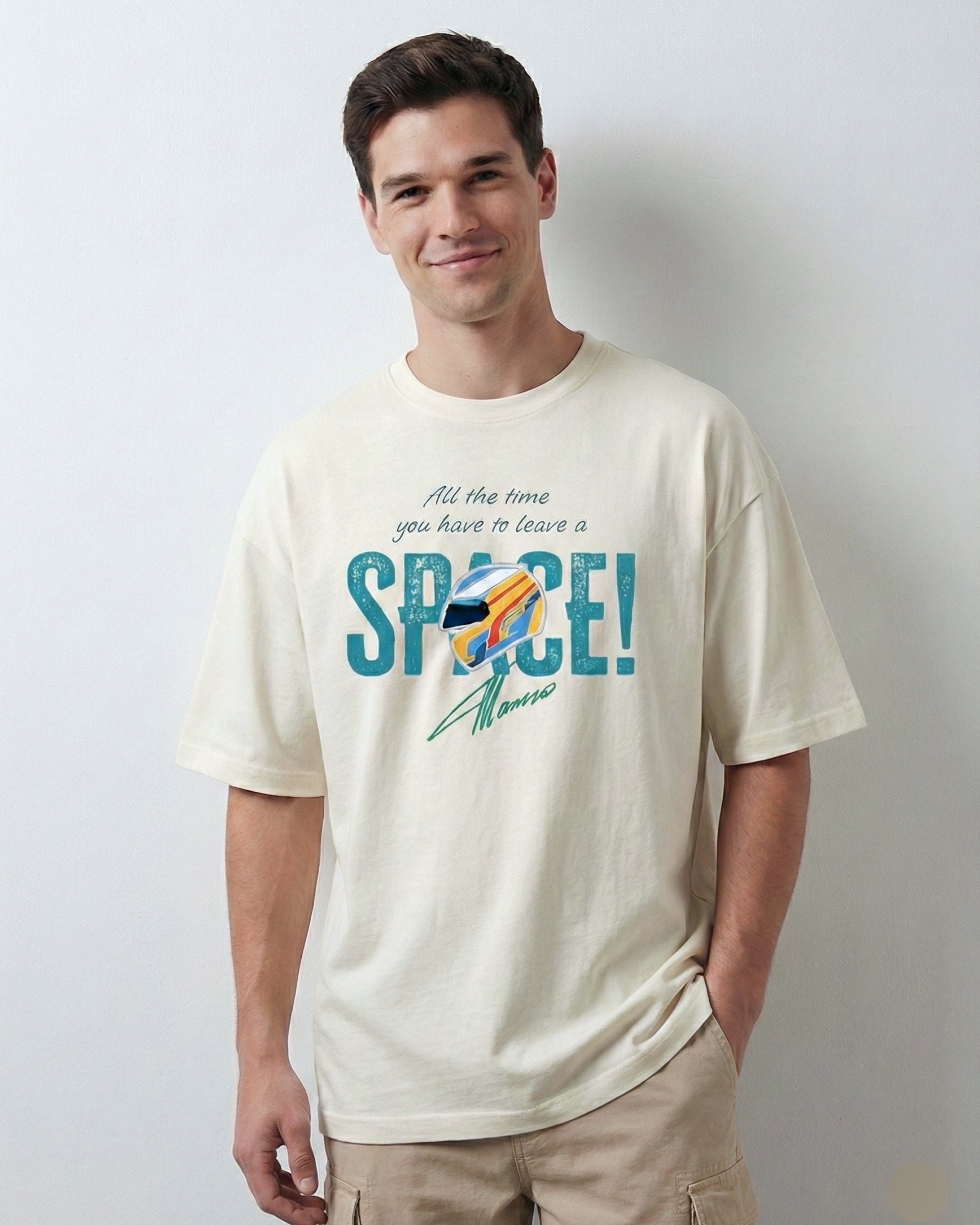 Male model wearing Off White oversized unisex F1 tshirt by Turn 1, an F1 apparel brand in India - fan graphic tee of Fernando Alonso, ex Mclaren Racing and Scuderia Ferrari F1 driver. Tshirt's front print features Fernando Alonso's signature, helmet and his famous quote "All the time you have to leave a space". 