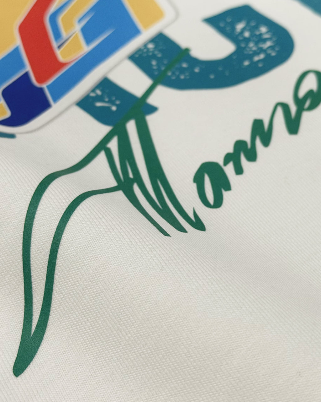 Close-up of Off White oversized unisex F1 tshirt by Turn 1, an F1 apparel brand in India - fan graphic tee of Fernando Alonso, ex Mclaren Racing and Scuderia Ferrari F1 driver. Tshirt's front print features Fernando Alonso's signature, helmet and his famous quote "All the time you have to leave a space". 