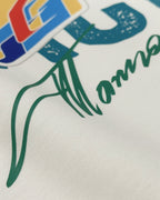 Close-up of Off White oversized unisex F1 tshirt by Turn 1, an F1 apparel brand in India - fan graphic tee of Fernando Alonso, ex Mclaren Racing and Scuderia Ferrari F1 driver. Tshirt's front print features Fernando Alonso's signature, helmet and his famous quote "All the time you have to leave a space". 