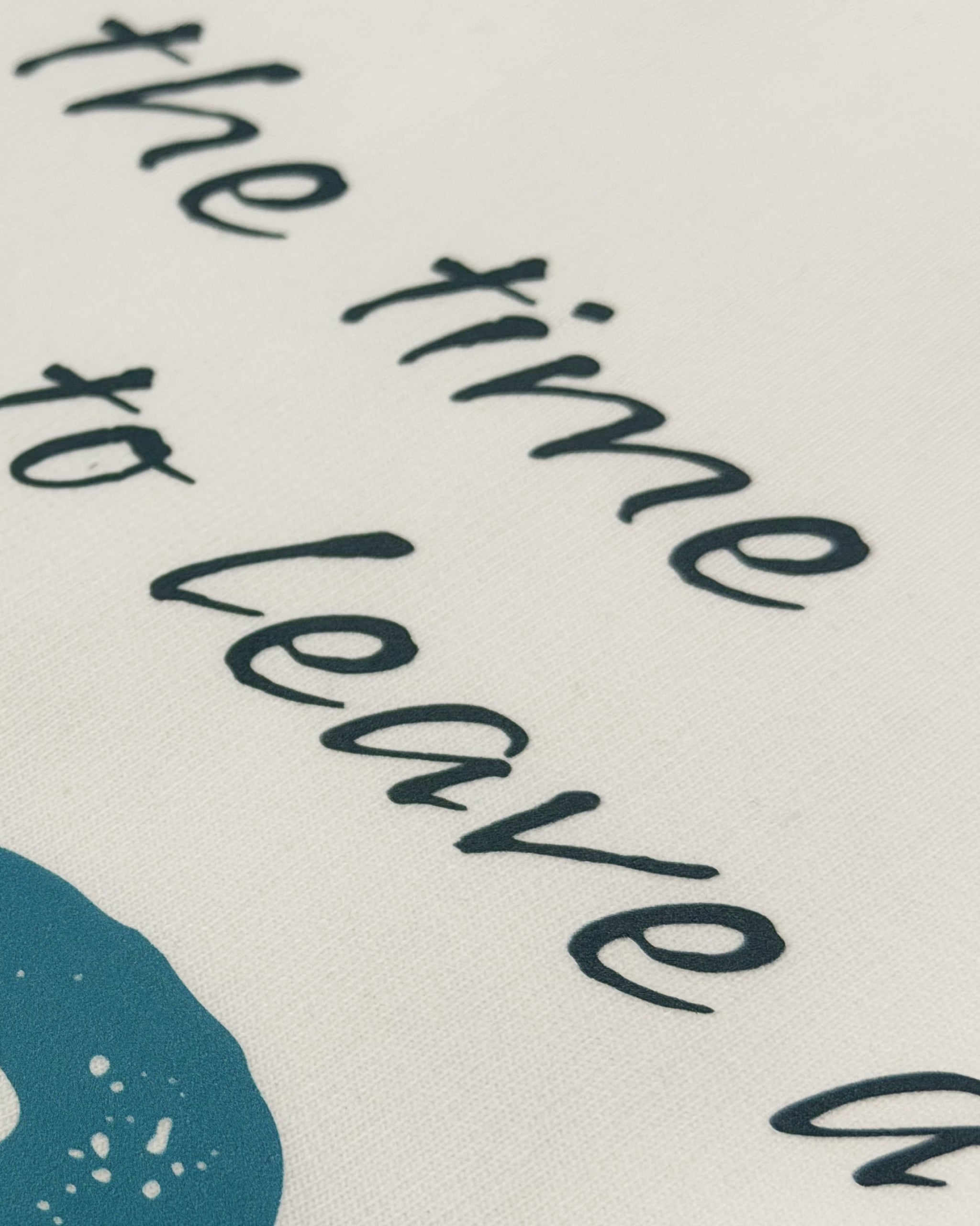 Close-up of Off White oversized unisex F1 tshirt by Turn 1, an F1 apparel brand in India - fan graphic tee of Fernando Alonso, ex Mclaren Racing and Scuderia Ferrari F1 driver. Tshirt's front print features Fernando Alonso's signature, helmet and his famous quote "All the time you have to leave a space". 