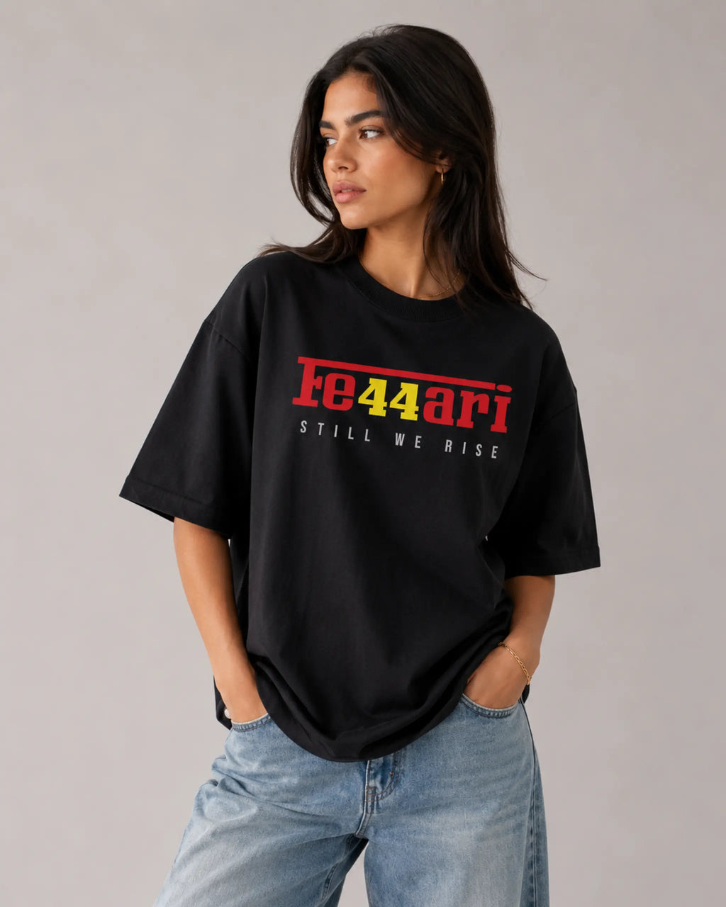 Female model woman wearing Lewis Hamilton Ferrari 44 Still We Rise F1 Unisex Oversized T-shirt Black Front View | Turn1 India