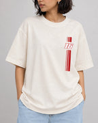 Female model wearing Charles Leclerc Ferrari F1 Unisex Oversized T-shirt Off-White Front View | Turn1 India