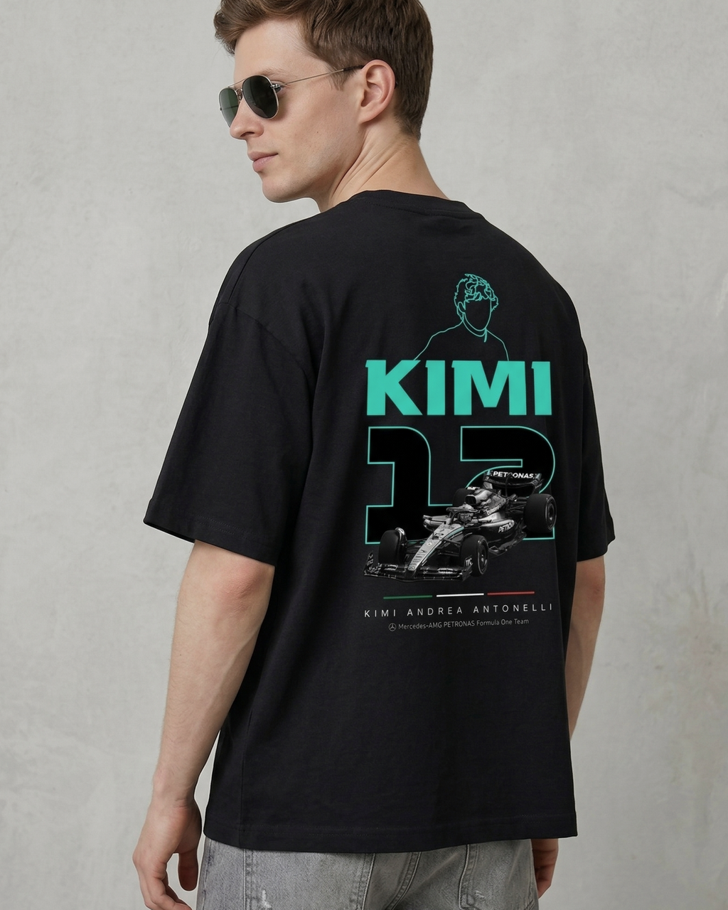 Male model wearing F1 Turn1 India Black unisex oversized tshirt featuring Kimi Antonelli, Mercedes AMG Petronas F1 Team driver, his Mercedes F1 car and number 12.
Front print featuring text "Silver Arrows"