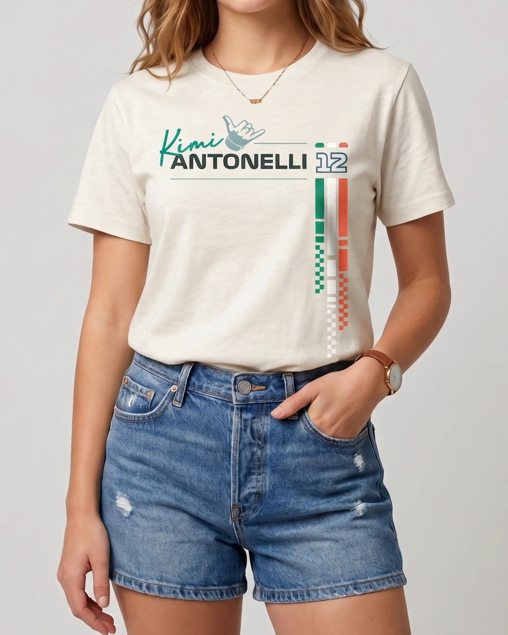Female  model wearing Off white regular fit unisex F1 tshirt by Turn 1, an F1 apparel brand in India - fan graphic tee of Kimi Antonelli, Mercedes AMG Petronas Formula 1 driver. Tshirt's front print features Kimi Antonelli's signature hand move, his number 12 and colors of Italian flag. 