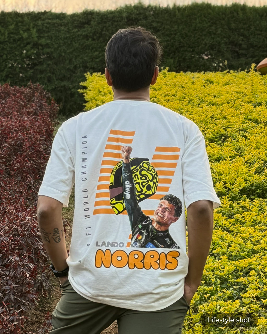 User Review picture of Turn1 India Off White oversized unisex tshirt - fan graphic tee of Lando Norris, Mclaren Racing F1 driver. Tshirt's back print features Lando Norris, his helmet and text "2025 F1 World Champion".
Front print of tshirt features Mclaren Racing logo and Lando Norris' logo initials