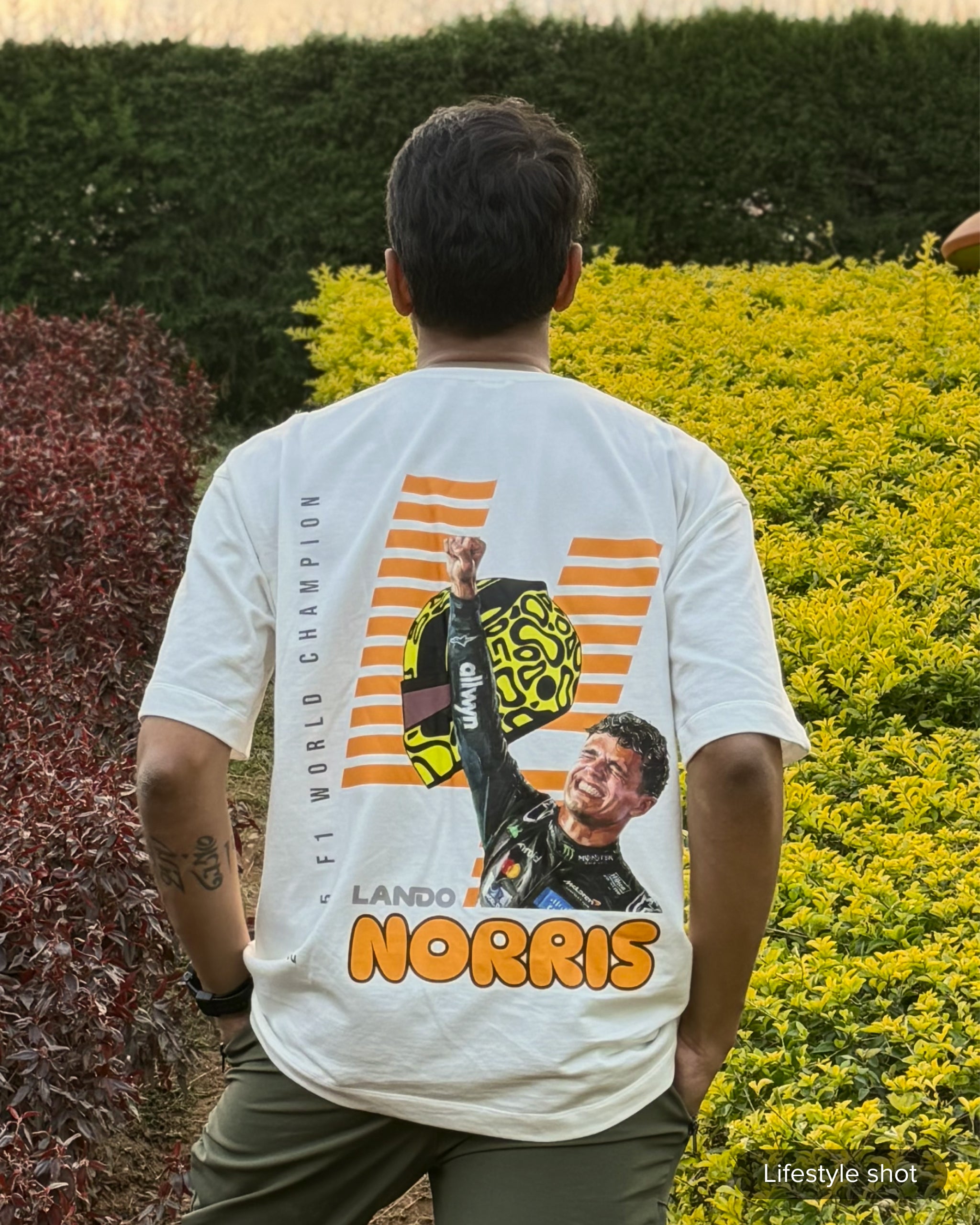 User Review picture of Turn1 India Off White oversized unisex tshirt - fan graphic tee of Lando Norris, Mclaren Racing F1 driver. Tshirt's back print features Lando Norris, his helmet and text "2025 F1 World Champion".
Front print of tshirt features Mclaren Racing logo and Lando Norris' logo initials
