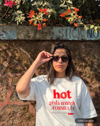 Lifestyle Image of girl wearing Hot Girls Watch Formula 1 F1 Oversized T-shirt Off-White Front View City Wall Background | Turn1 India