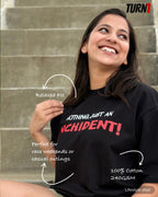 A woman smiling while wearing a black crewneck Formula 1 Charles Leclerc inspired F1 t-shirt with the text 'NOTHING, JUST AN INCIDENT!' printed in white and red. The image features descriptive text overlays highlighting the relaxed fit, suitability for casual outings, and fabric details, set against a gray stone staircase background.
