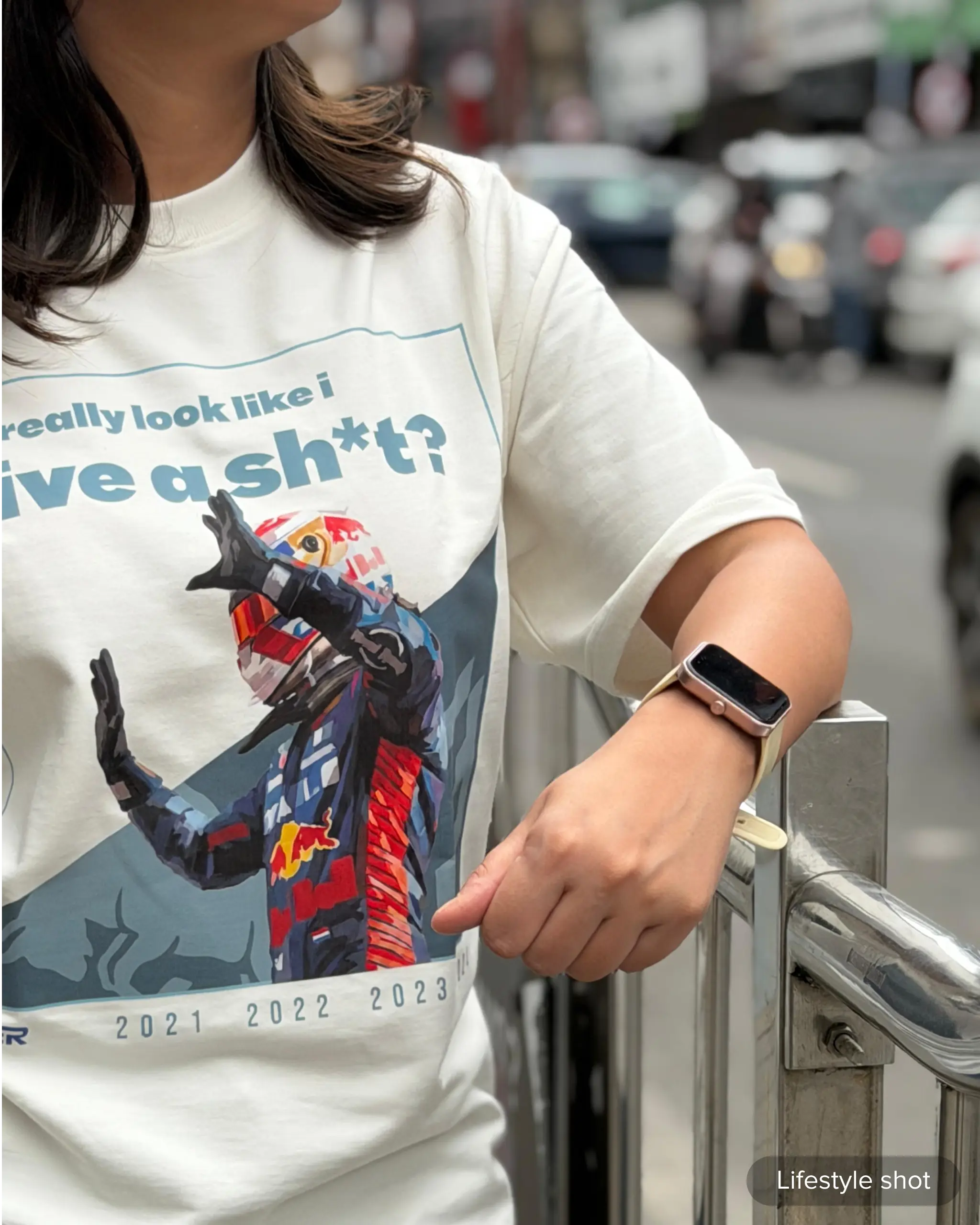 Lifestyle image of woman wearing Max Verstappen Attitude Don't Give a Sh*t F1 Unisex Oversized T-shirt Off-White Front View | Turn1 India