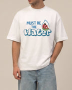 Male model wearing Charles Leclerc Ferrari Must Be The Water F1 Unisex Oversized T-shirt Off-White Front View | Turn1 India