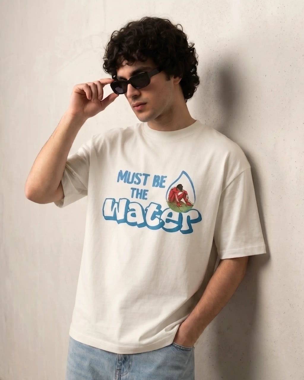 Male model wearing Charles Leclerc Ferrari Must Be The Water F1 Unisex Oversized T-shirt Off-White Front View | Turn1 India