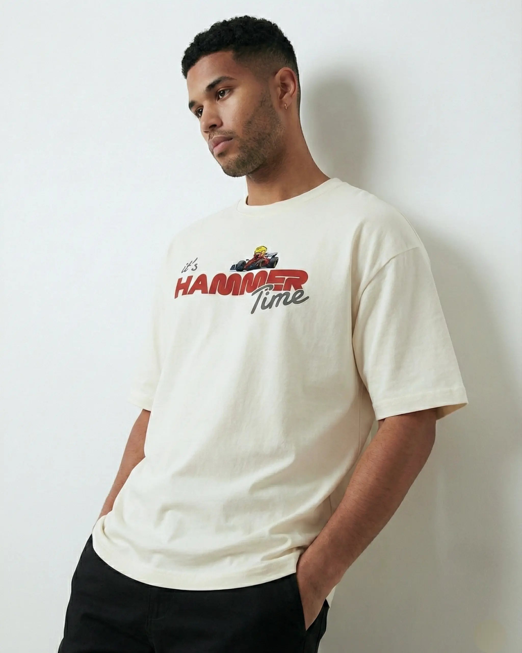 Male model wearing Lewis Hamilton It's Hammertime F1 Unisex Oversized T-shirt Off-White Front View | Turn1 India