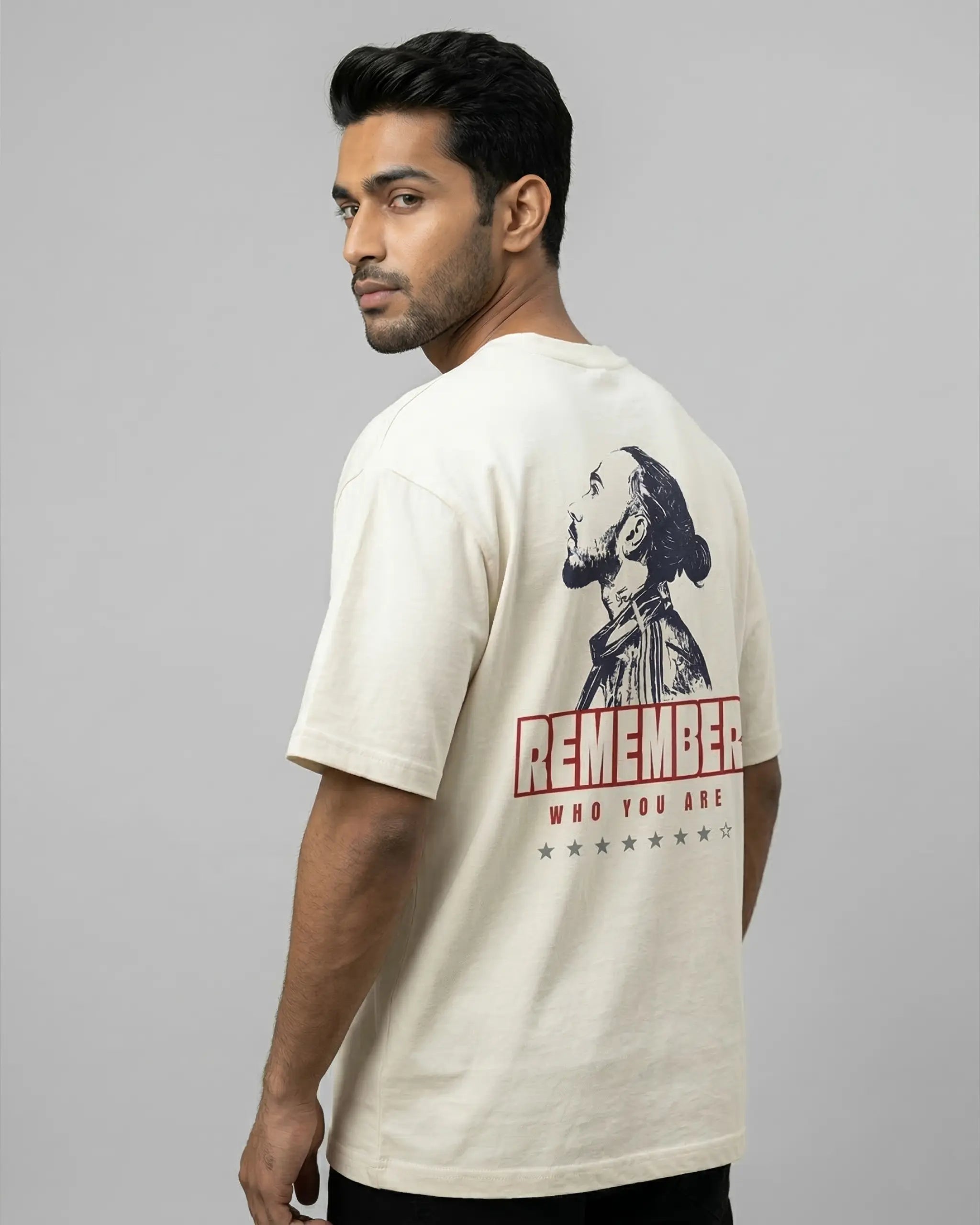 Male model wearing Lewis Hamilton Remember Who You Are Quote F1 Unisex Oversized T-shirt Off-White Back View | Turn1 India
