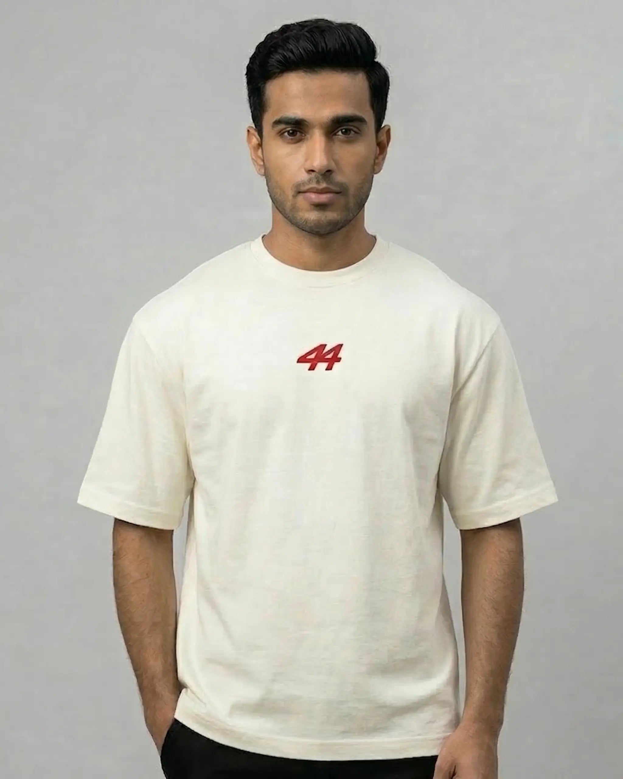 Male model wearing Lewis Hamilton Remember Who You Are Quote F1 Unisex Oversized T-shirt Off-White Front View | Turn1 India