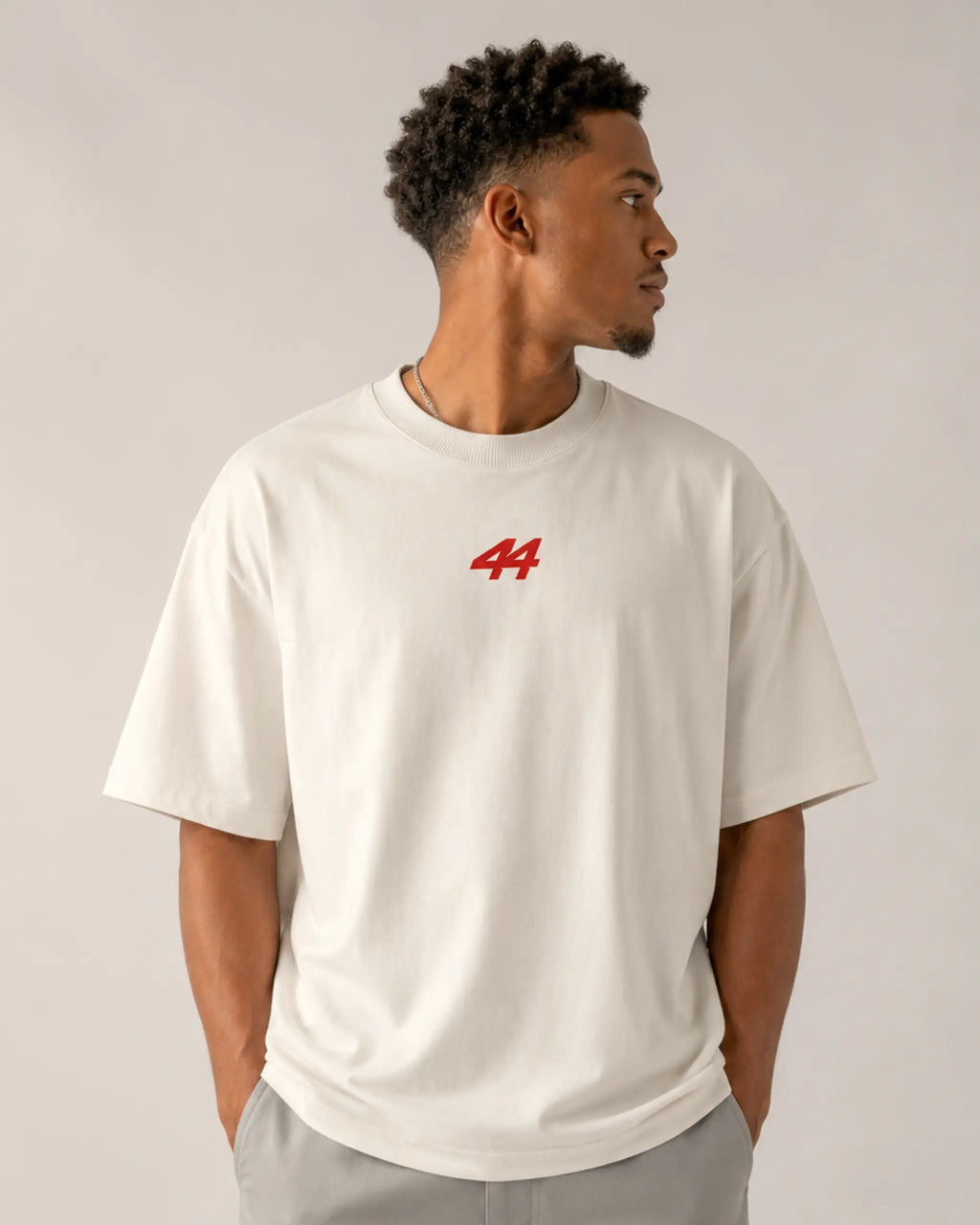 Male model wearing Lewis Hamilton Quote Remember Who You Are Fan Ferrari Graphic F1 Unisex Oversized T-shirt Off-White Front View | Turn1 India | Premium Cotton