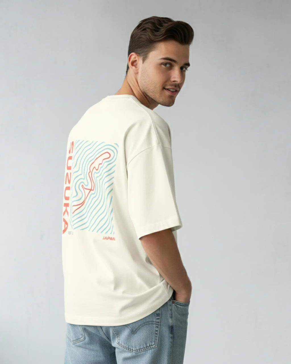 Male model wearing Suzuka Circuit Japan Grand Prix F1 Unisex Oversized Graphic T-shirt Off-White Side View | Turn1 India