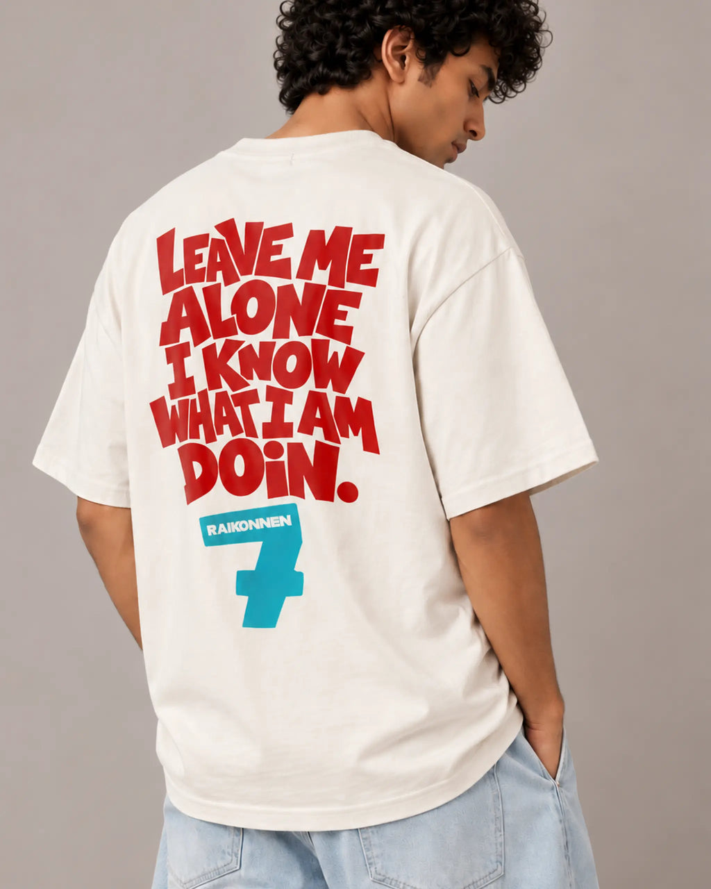 Male model man wearing Kimi Raikkonen The Iceman F1 T-shirt | Kimi Raikkonen Formula 1 Tee India | Off-White | Unisex Oversized Fit | Back View | Turn1 India
