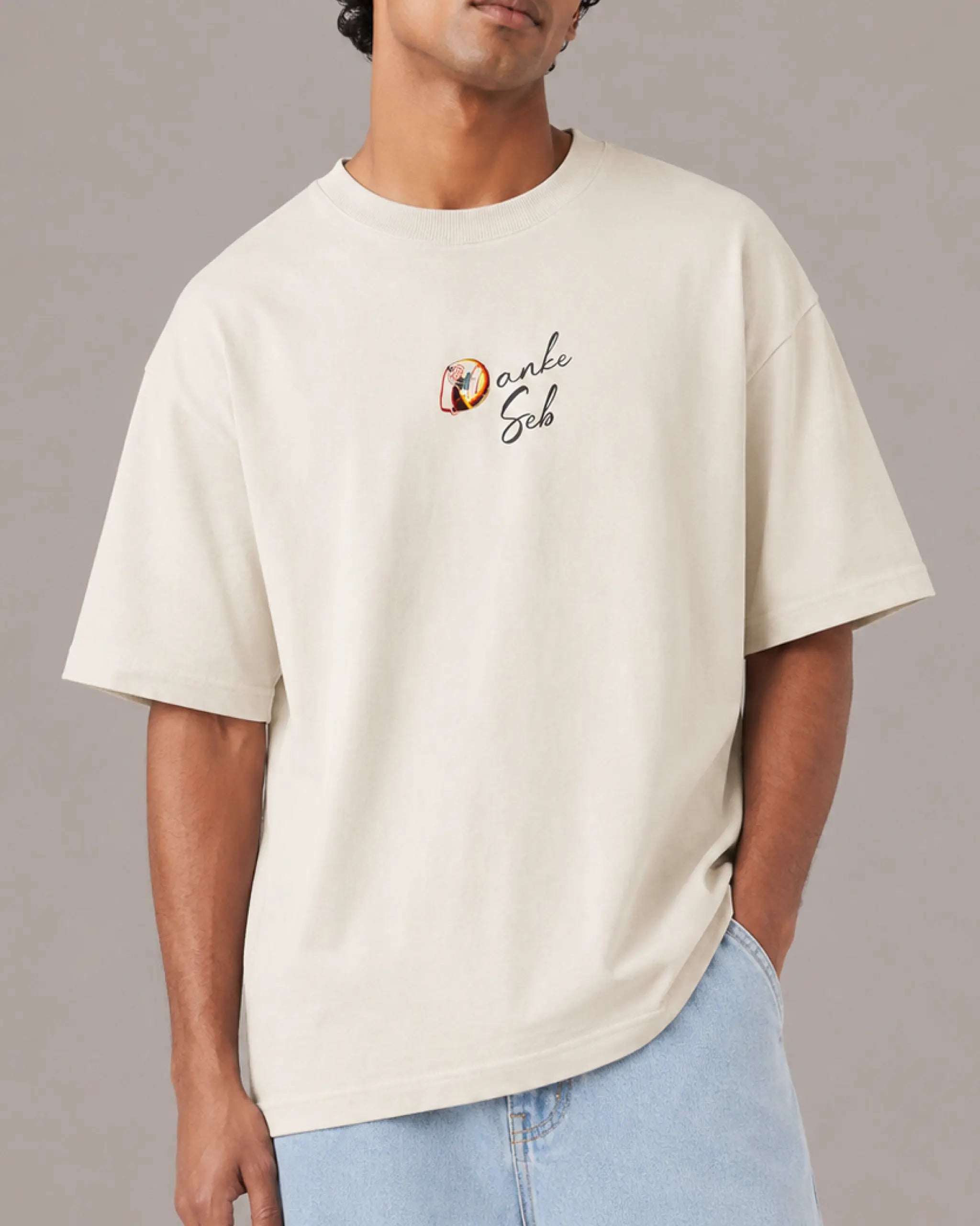 Male model man wearing Sebastian Vettel Danke Seb Formula 1 Graphic F1 T-shirt Off-White Front View | Turn1 India | Unisex Oversized Tee
