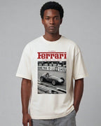 Male model wearing Vintage Ferrari F1 Turn1 India off white oversized unisex tshirt - F1 Ferrari 1954 car graphic on front along with Scuderia Ferrari Formula One Team in red