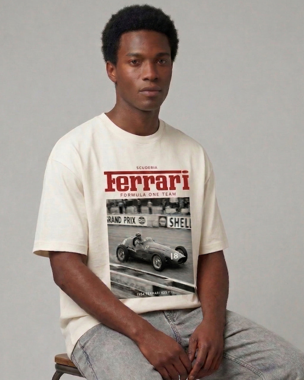Male model wearing Vintage Ferrari F1 Turn1 India off white oversized unisex tshirt - F1 Ferrari 1954 car graphic on front along with Scuderia Ferrari Formula One Team in red