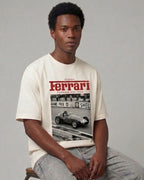 Male model wearing Vintage Ferrari F1 Turn1 India off white oversized unisex tshirt - F1 Ferrari 1954 car graphic on front along with Scuderia Ferrari Formula One Team in red