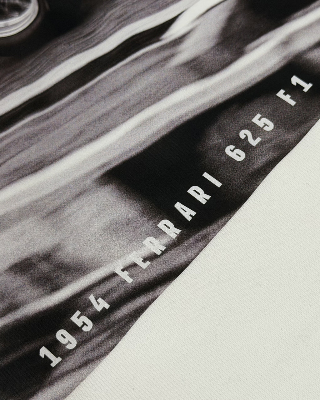 Close-up of Vintage Ferrari F1 Turn1 India off white oversized unisex tshirt - F1 Ferrari 1954 car graphic on front along with Scuderia Ferrari Formula One Team in red