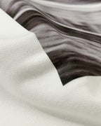 close-up showing ribbed sleeve hem and soft jersey texture of Vintage Ferrari F1 Turn1 India off white oversized unisex tshirt - F1 Ferrari 1954 car graphic on front along with Scuderia Ferrari Formula One Team in red