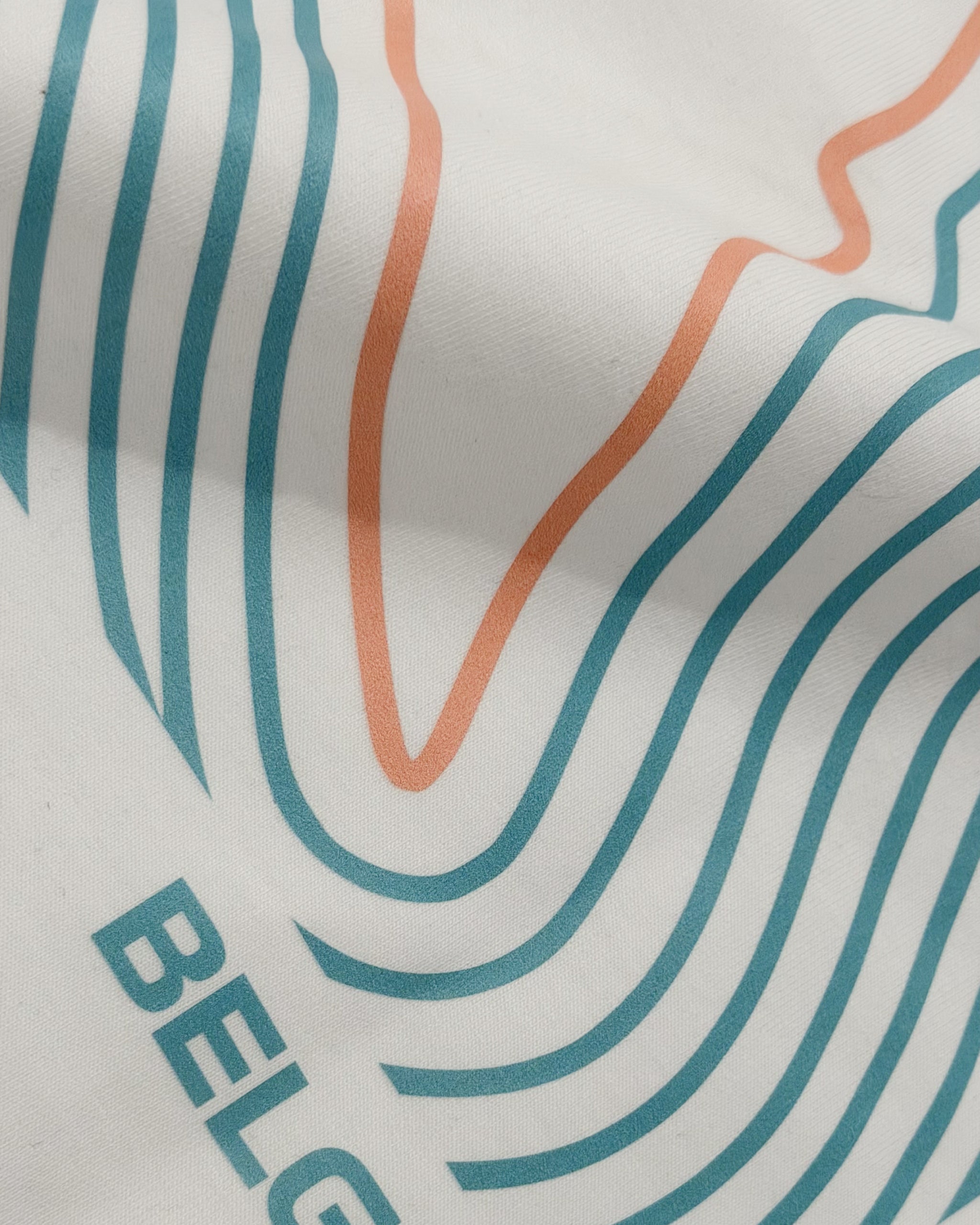 Closeup of premium cotton fabrice and print of F1 Off-white unisex oversized T-shirt by Turn 1 Brand, an F1 Apparel brand of India. Back print features Spa Francorchamps Belgium GP F1 circuit. Front print features a miniature F1 sports car.