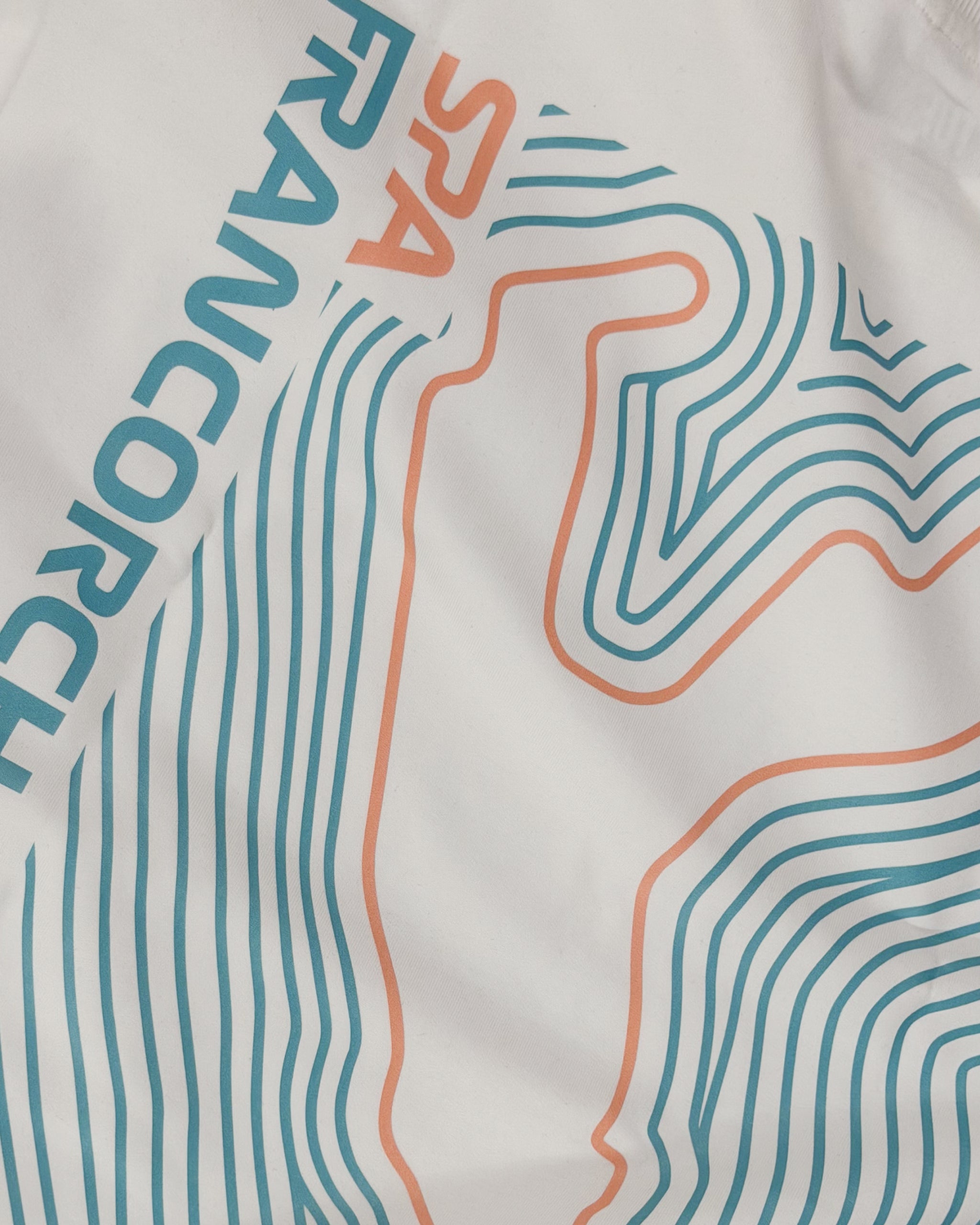 Closeup of premium cotton fabrice and print of F1 Off-white unisex oversized T-shirt by Turn 1 Brand, an F1 Apparel brand of India. Back print features Spa Francorchamps Belgium GP F1 circuit. Front print features a miniature F1 sports car.